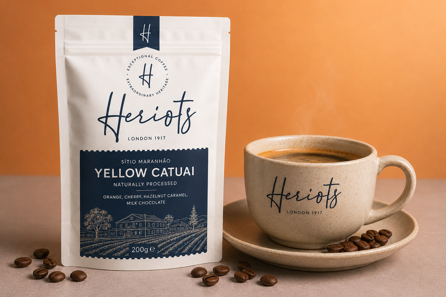 A stand-up pouch of Heriots Yellow Catuai coffee stands next to a ceramic cup of coffee on a saucer, with scattered coffee beans on a warm orange-brown background.